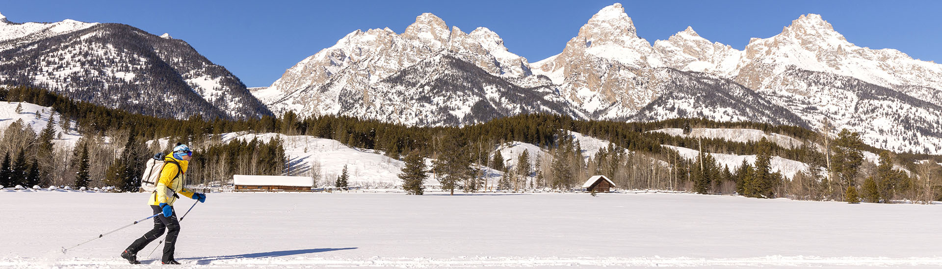 woman cross country skiing in front of Grand Tetons
