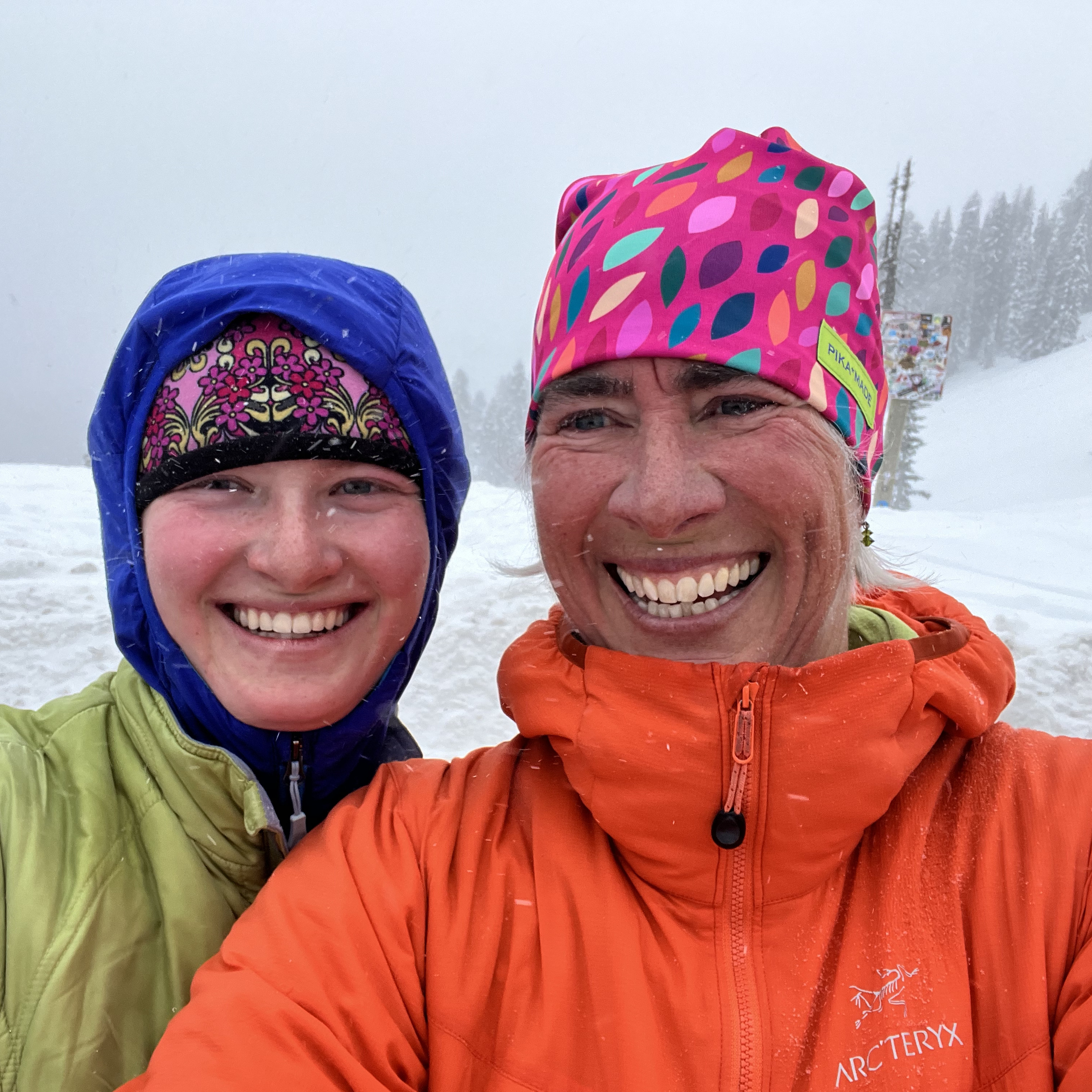 two smiling people in winter storm